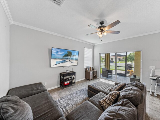 tiled living room with ceiling fan, crown molding, and a textured ceiling