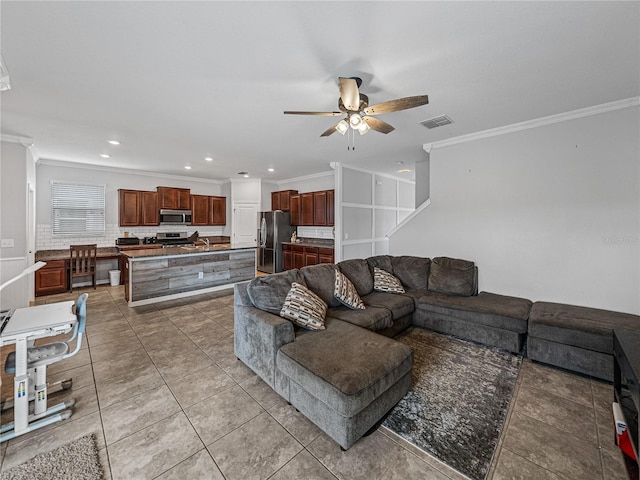 living room featuring ornamental molding, tile patterned flooring, and ceiling fan