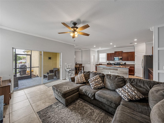 tiled living room with crown molding, a textured ceiling, and ceiling fan