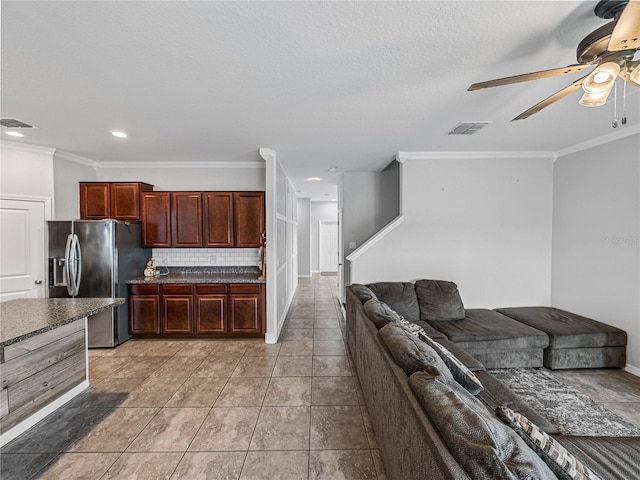 kitchen with ceiling fan, light tile patterned floors, backsplash, stainless steel fridge with ice dispenser, and crown molding