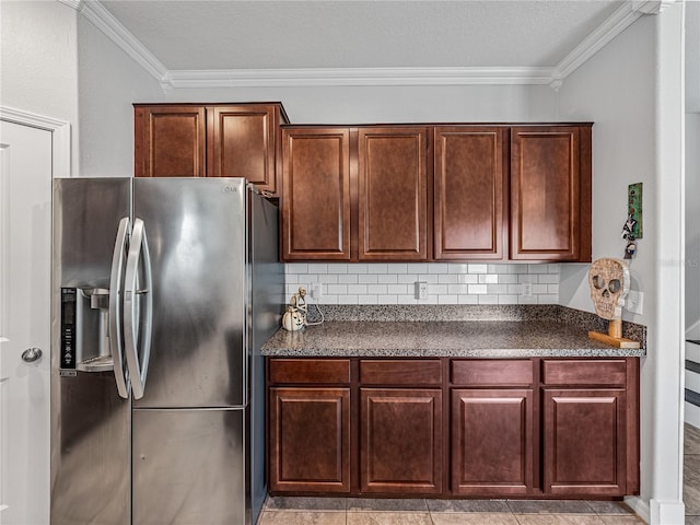 kitchen featuring ornamental molding, stainless steel refrigerator with ice dispenser, light tile patterned floors, and backsplash