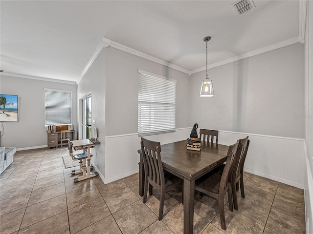 8720 Savory Walk Dr, Land O Lakes, FL 34637 - dining space featuring crown molding, a wainscoted wall, tile patterned floors, and visible vents