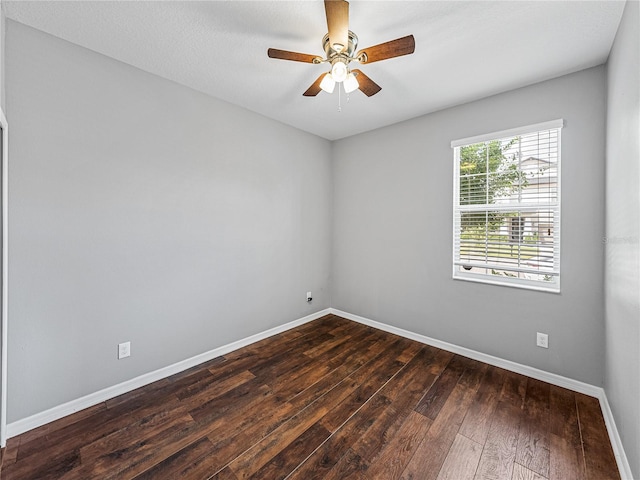 empty room featuring dark wood-type flooring and ceiling fan