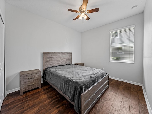 bedroom with a closet, ceiling fan, and dark hardwood / wood-style flooring