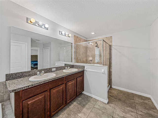 bathroom with vanity, tile patterned flooring, a textured ceiling, and an enclosed shower