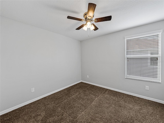 carpeted spare room with a textured ceiling and ceiling fan