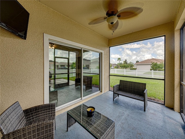 sunroom featuring ceiling fan