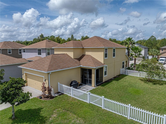 8720 Savory Walk Dr, Land O Lakes, FL 34637 - back of property with a garage, stucco siding, a sunroom, a lawn, and driveway