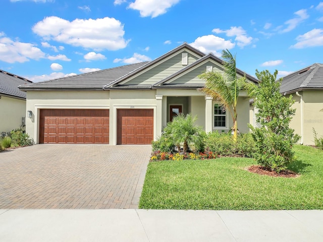 view of front facade with a garage and a front lawn