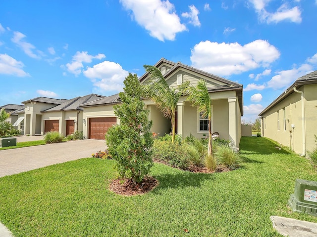 view of front facade with a front yard and a garage