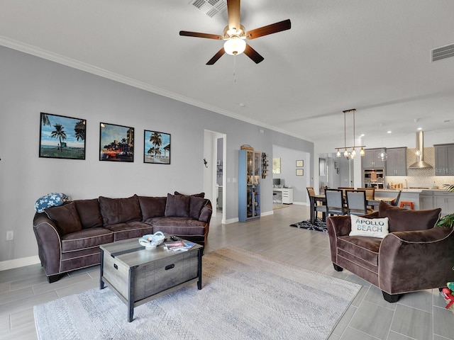 living room with ornamental molding and ceiling fan with notable chandelier