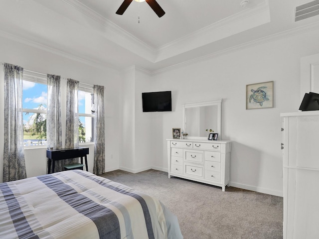 bedroom with crown molding, a raised ceiling, light colored carpet, and ceiling fan