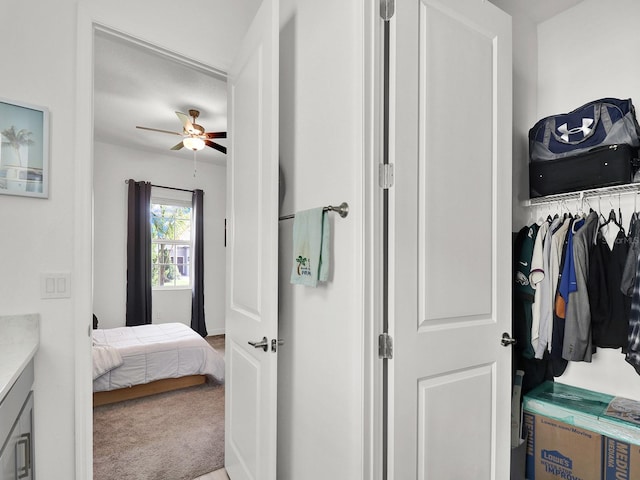 carpeted bedroom with a closet and ceiling fan