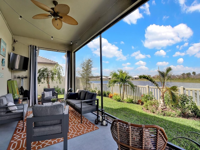 view of patio / terrace with a water view, ceiling fan, and an outdoor living space