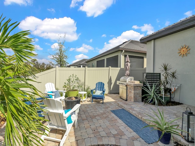 view of patio / terrace featuring an outdoor fire pit