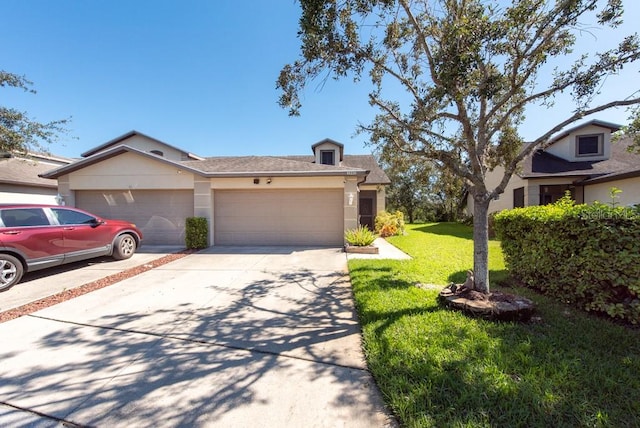 view of front of house with a front yard and a garage