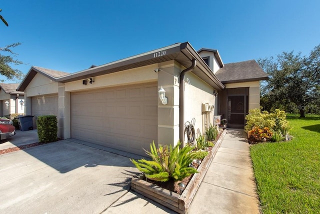 view of front of property with a front yard and a garage