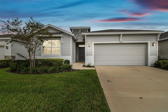 ranch-style house with a lawn and a garage