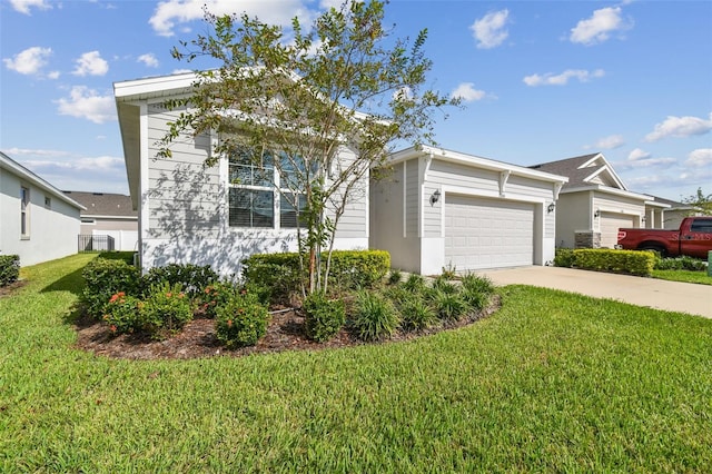 view of front of property with a front yard and a garage