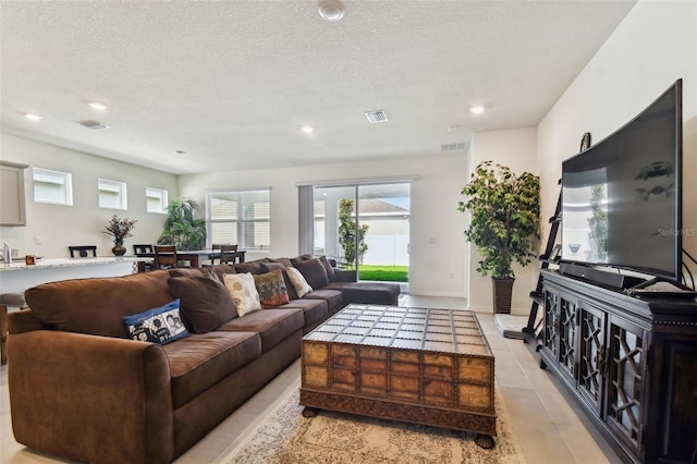 tiled living room with a textured ceiling