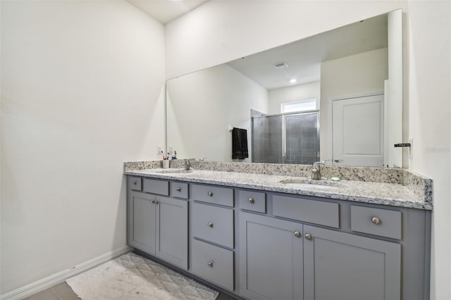 bathroom featuring vanity, tile patterned floors, and walk in shower