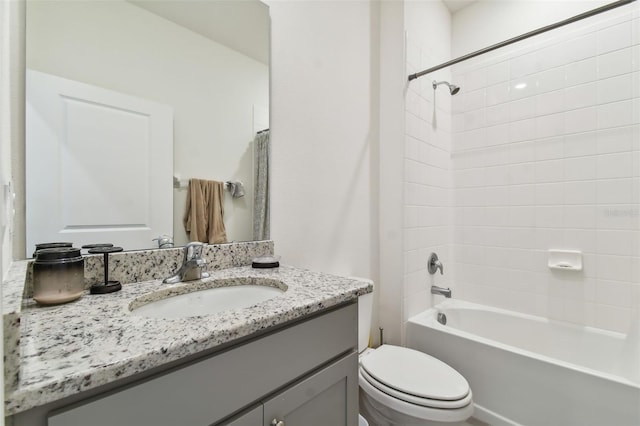 full bathroom with vanity, shower / bath combo, and toilet