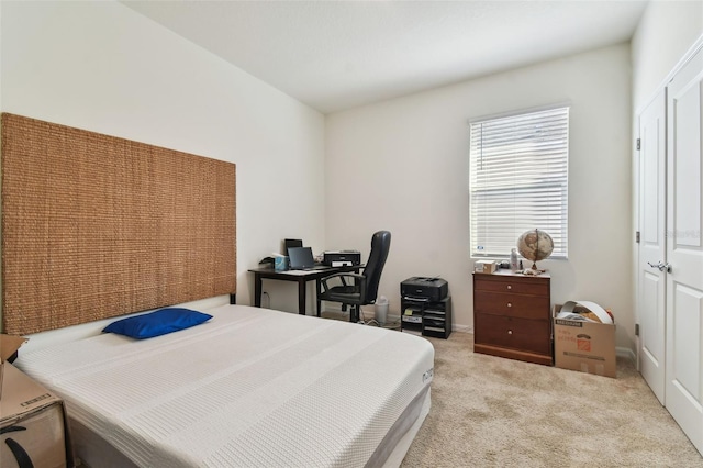 bedroom featuring light carpet