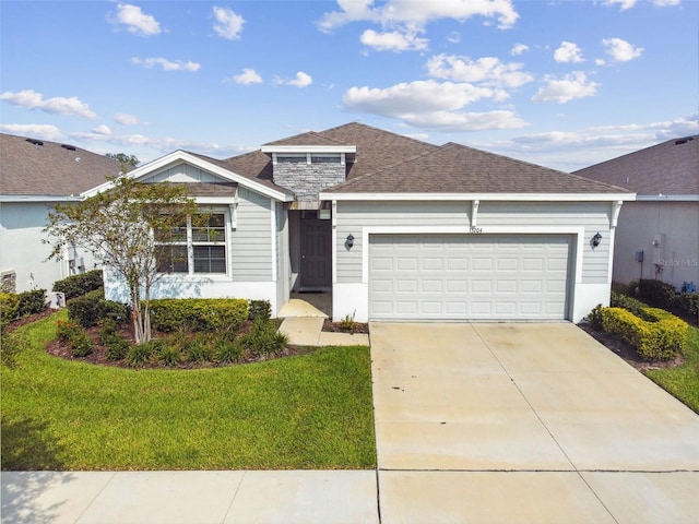 view of front facade with a front yard and a garage