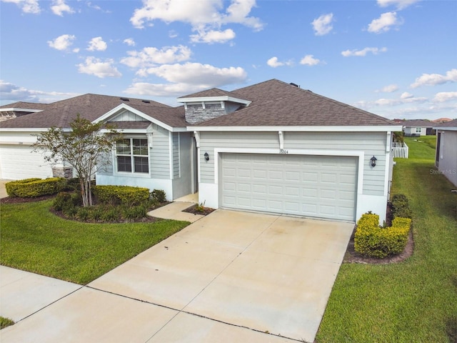 view of front of home with a front yard and a garage