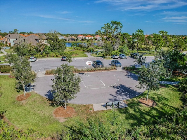 view of sport court with a lawn