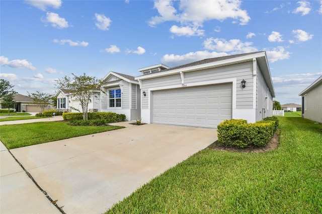 view of front facade with a garage and a front lawn