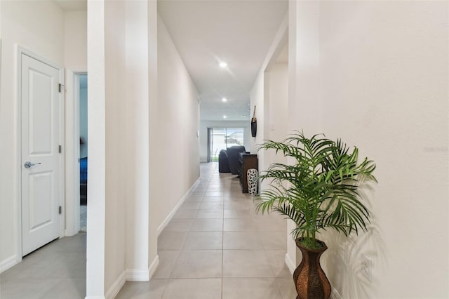 hall with light tile patterned floors