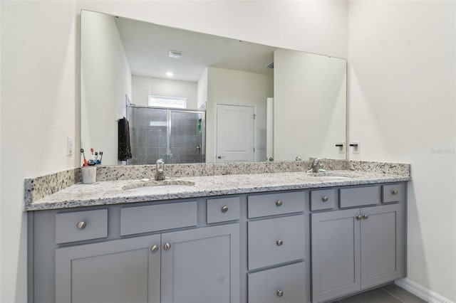 bathroom with vanity and a shower with door