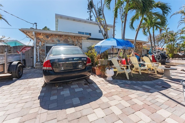 14180 W Parsley Dr, Madeira Beach, FL 33708 - exterior space featuring stone siding and fence