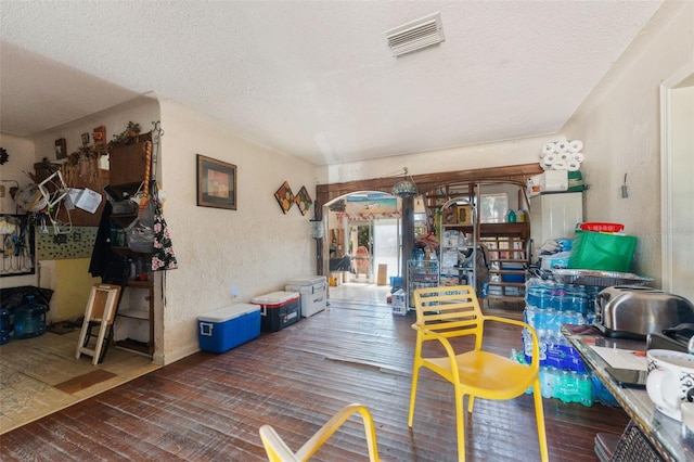 14180 W Parsley Dr, Madeira Beach, FL 33708 - interior space with wood-type flooring, a textured ceiling, a textured wall, and visible vents
