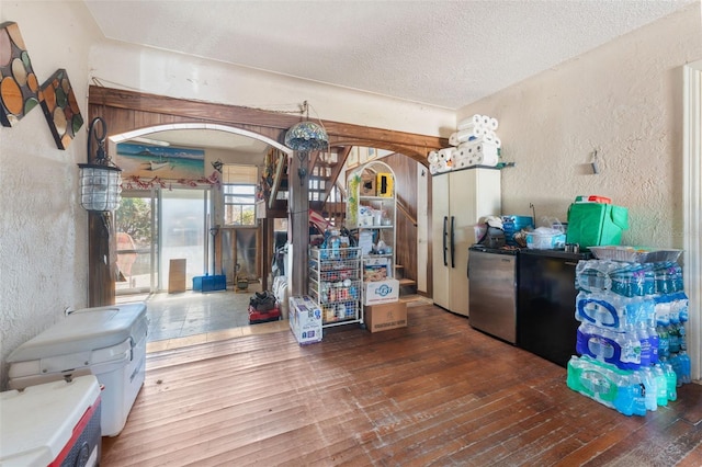 kitchen with a textured ceiling and dark hardwood / wood-style flooring