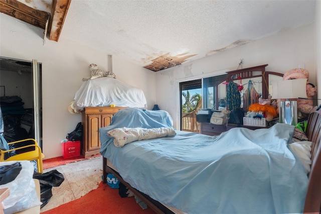 14180 W Parsley Dr, Madeira Beach, FL 33708 - bedroom with a textured ceiling and access to exterior