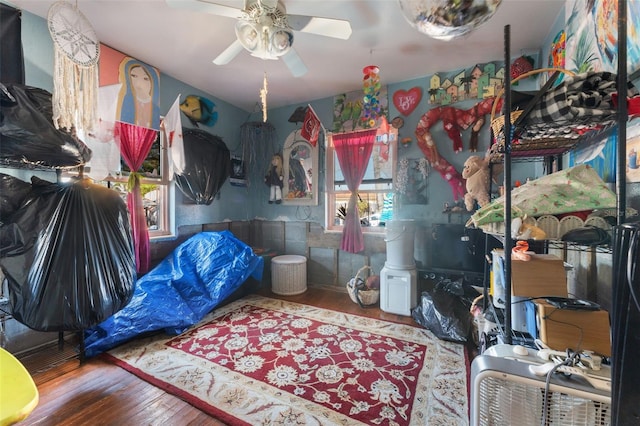 bedroom with hardwood / wood-style floors and ceiling fan