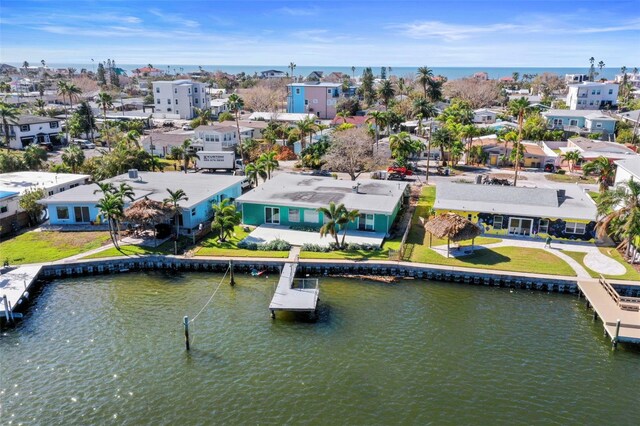 drone / aerial view featuring a residential view and a water view