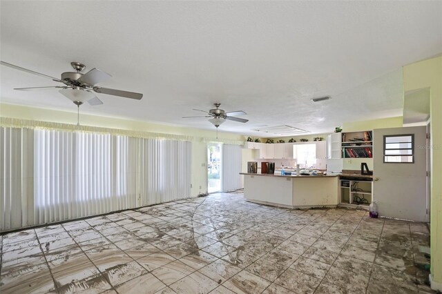 living area featuring visible vents and ceiling fan