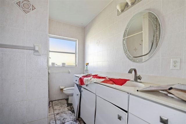 bathroom featuring vanity, toilet, and tile walls