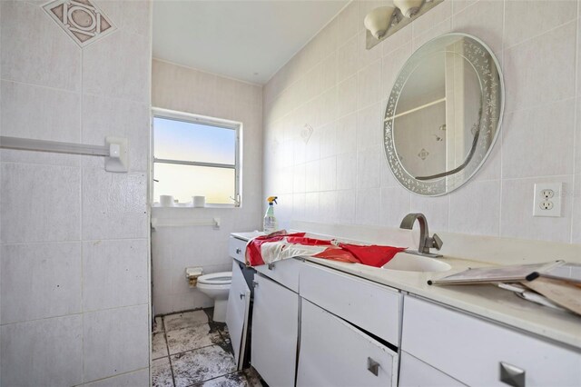 bathroom with decorative backsplash, toilet, vanity, and tile walls