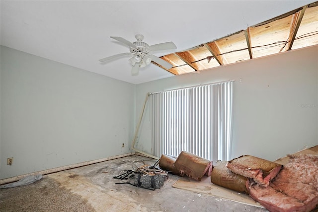 interior space featuring ceiling fan and multiple windows