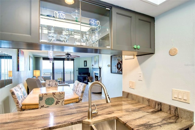 kitchen with a ceiling fan, a wealth of natural light, and gray cabinetry