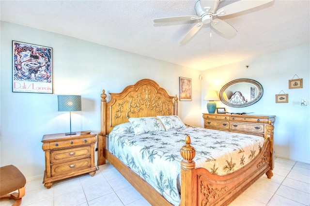 bedroom with a textured ceiling, ceiling fan, light tile patterned floors, and baseboards