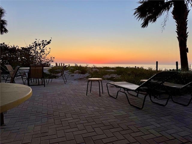 patio terrace at dusk with a water view