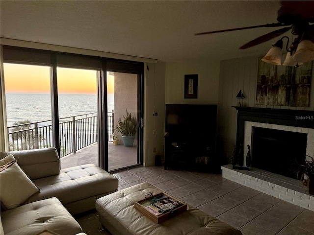 living room with tile patterned flooring, a fireplace, and ceiling fan