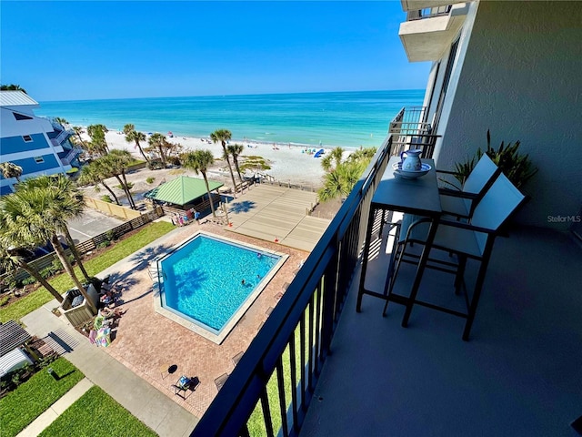 community pool with view of water and beach