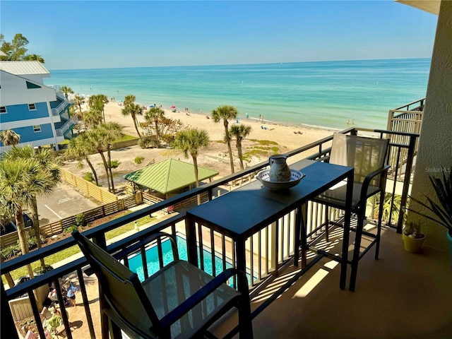 balcony with view of water and beach