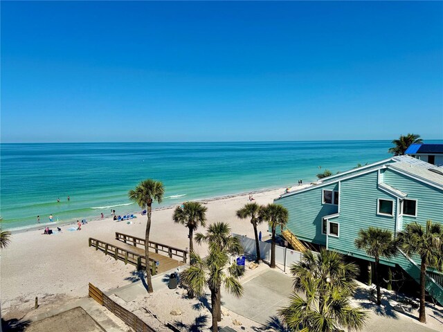 water view featuring nearby beach and fence